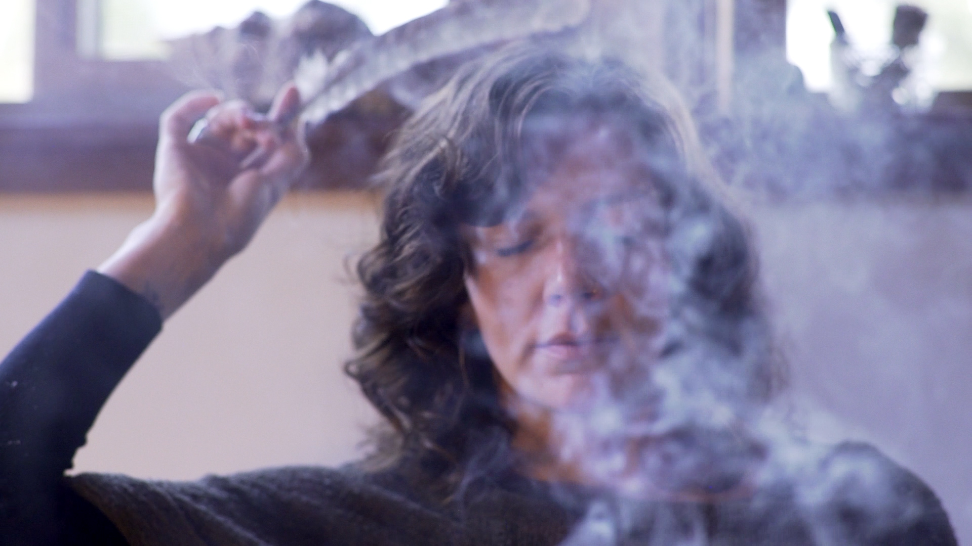 Lauren in stillness, sage smoke drifting through soft light